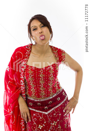 Young Indian woman sticking out her tongue Young Indian woman sticking out her tongue 11172778