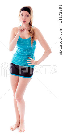 Young woman standing with finger on lips 11172891