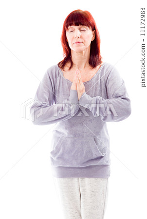 Mature woman standing in prayer position 11172983