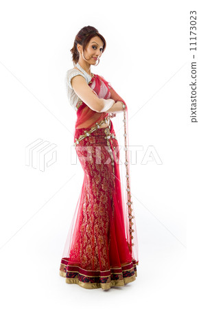 Young Indian woman standing with her arms crossed Young Indian woman standing with her arms crossed 11173023