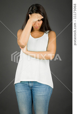 Upset young woman with her head in hands 11173068