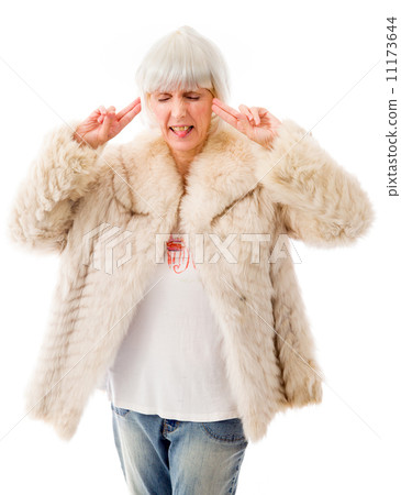 Senior woman standing with fingers in her ears 11173644