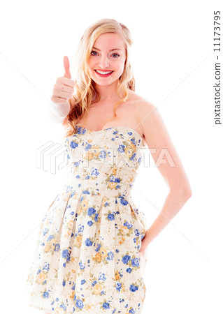 Beautiful young woman standing and showing thumbs up sign 11173795