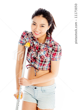 Isolated on white sexy asian cowgirl injured with a crutch 11173850