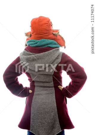 Rear view of a young woman in warm clothing and standing with ar Rear view of a young woman in warm clothing and standing with ar 11174074