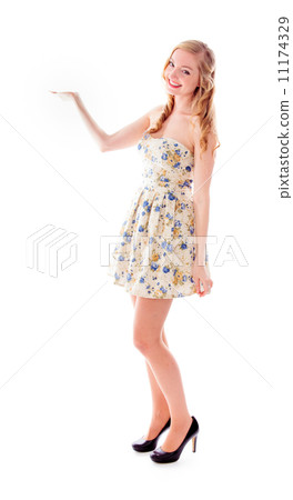Beautiful young woman standing with her arm outstretched 11174329