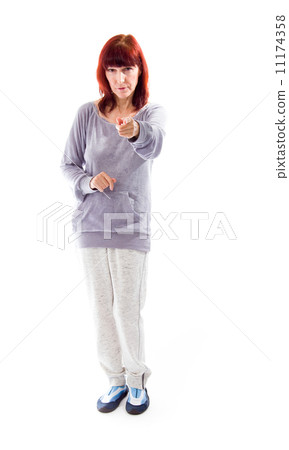 Mature woman pointing towards camera Mature woman pointing towards camera 11174358