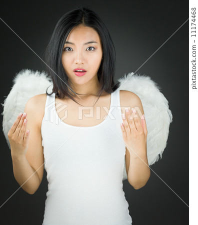 Shocked Asian young woman dressed up as an angel gesturing Shocked Asian young woman dressed up as an angel gesturing 11174468