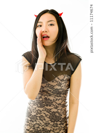 Asian young woman dressed up as a devil and whispering isolated on white background Asian young woman dressed up as a devil and whispering isolated on white background 11174674
