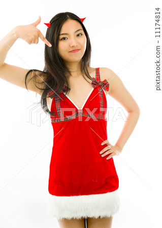 Devil side of a young Asian woman pointing and smiling isolated on white background Devil side of a young Asian woman pointing and smiling isolated on white background 11174814