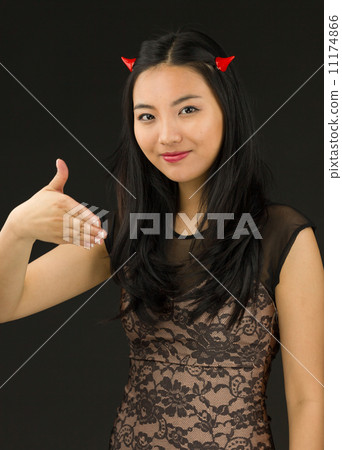 Asian young woman dressed up as an devil offering hand for handshake Asian young woman dressed up as an devil offering hand for handshake 11174866