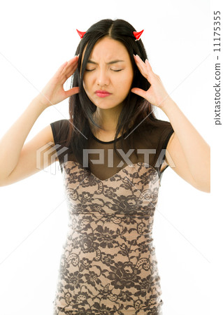 Asian young woman dressed up as a devil and suffering from headache isolated on white background Asian young woman dressed up as a devil and suffering from headache isolated on white background 11175355