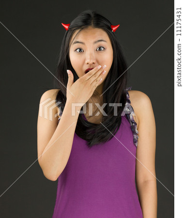 Devil side of a young Asian woman looking shocked 11175431
