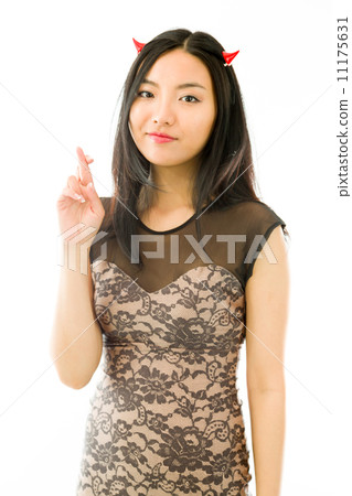 Asian young woman dressed up as a devil and showing her fingers crossed isolated on white background 11175631