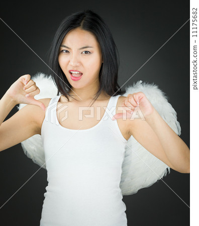 Asian young woman dressed up as an angel showing thumbs down sign from both hands 11175682