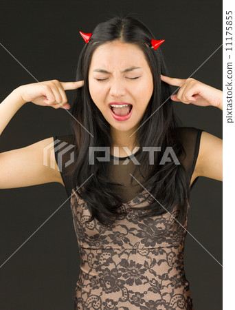 Young woman pretending to be a devil shouting in frustration 11175855