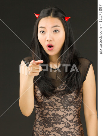 Asian young woman dressed up as an devil scolding somebody 11175897