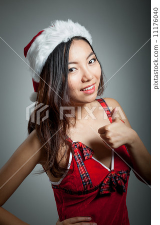 Sexy asian santa claus on grey backgroound with a thumb s up 11176040