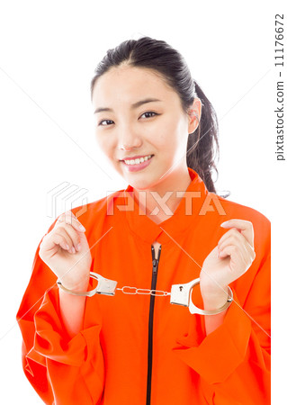 Handcuffed Asian young woman smiling in prisoners uniform 11176672