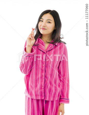 Young Asian woman standing with finger crossed 11177060