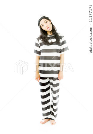 Young Asian woman sticking out her tongue in prisoners uniform 11177172