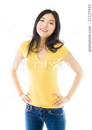 Young Asian woman standing with her arms akimbo Young Asian woman standing with her arms akimbo 11177433