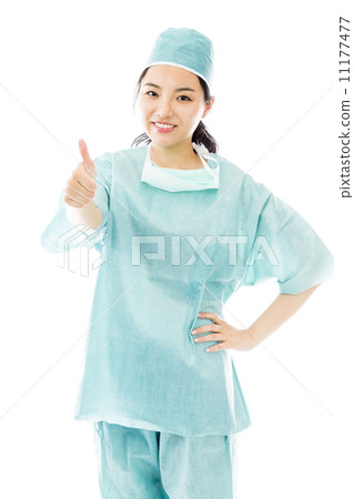Asian female surgeon making thumbs up sign standing with hand on hip 11177477