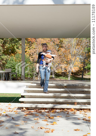 Woman carrying her baby boy and moving in a park Woman carrying her baby boy and moving in a park 11178189