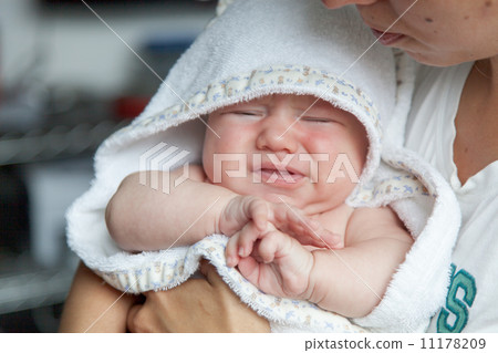 Woman carrying her crying baby boy Woman carrying her crying baby boy 11178209