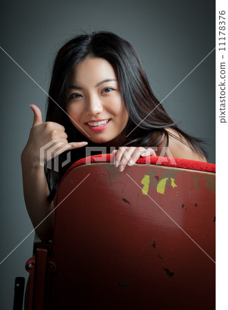 Attractive Asian girl 20s at the theatre isolate white backgroun 11178376