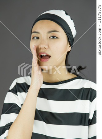 Young Asian woman whispering in prisoners uniform 11178578