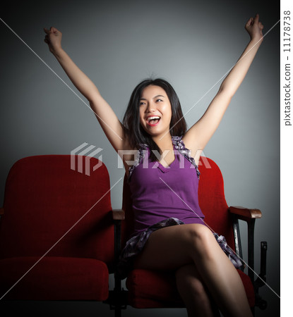 Attractive Asian girl 20s at the theatre isolate white backgroun 11178738