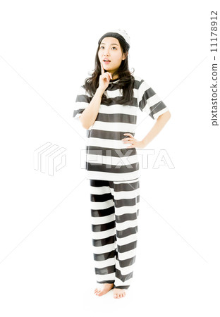 Young Asian woman with finger on chin in prisoners uniform Young Asian woman with finger on chin in prisoners uniform 11178912