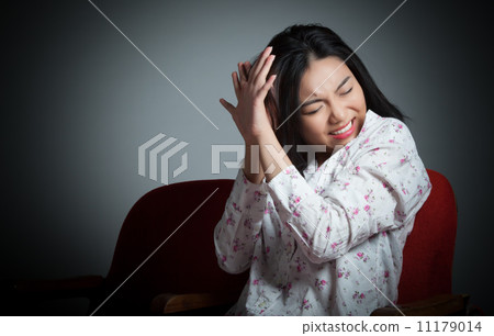 Attractive Asian girl 20s at the theatre isolate white backgroun 11179014