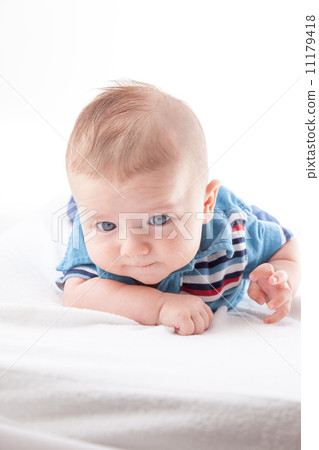 Close-up of a baby boy lying on the bed Close-up of a baby boy lying on the bed 11179418