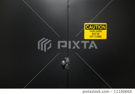 Caution sign on a closed door Caution sign on a closed door 11180668