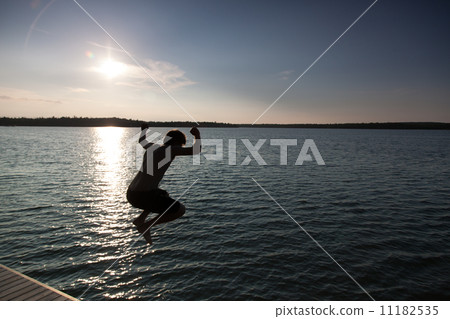Silhouette of a man diving in a bay, Georgian Bay, Tobermory, On 11182535