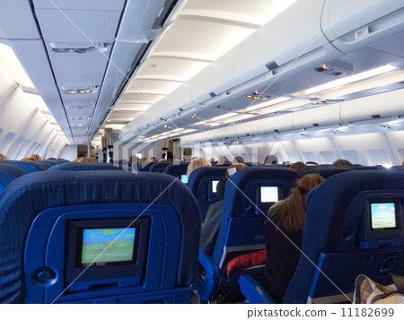 Passengers sitting in an airplane Passengers sitting in an airplane 11182699