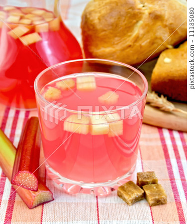 Compote from rhubarb in glass and jug on cloth with bread Compote from rhubarb in glass and jug on cloth with bread 11185080