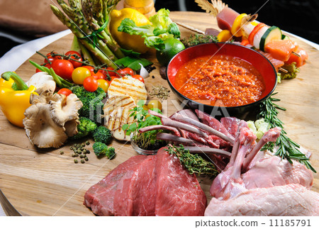 Abundance of raw food on a wooden board 11185791