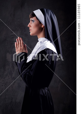 Young attractive nun praying 11185985