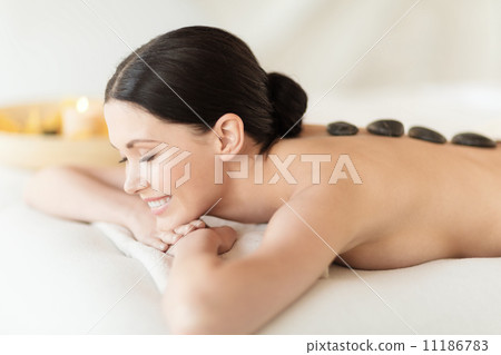 woman in spa with hot stones woman in spa with hot stones 11186783