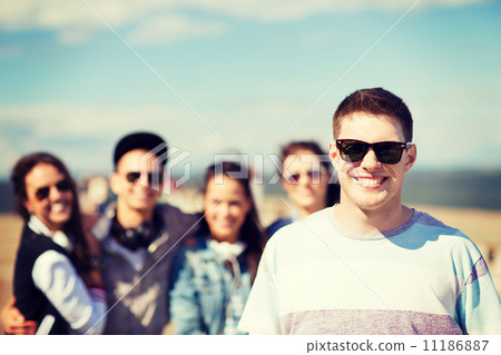 teenager in shades outside with friends 11186887