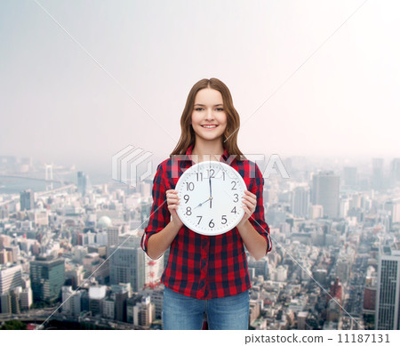 young woman in casual clothes with wall clock young woman in casual clothes with wall clock 11187131