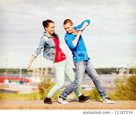 couple of teenagers dancing outside 11187254
