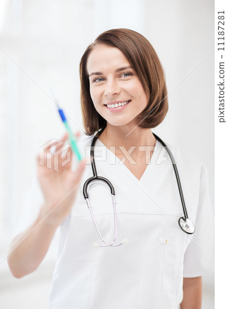 female doctor holding syringe with injection female doctor holding syringe with injection 11187281