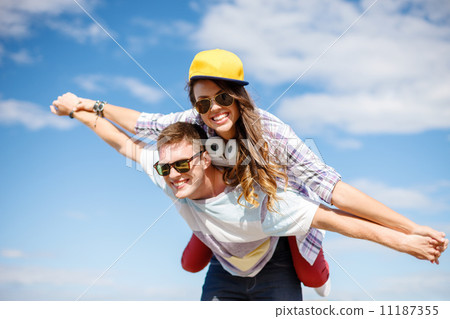 smiling teenagers in sunglasses having fun outside 11187355