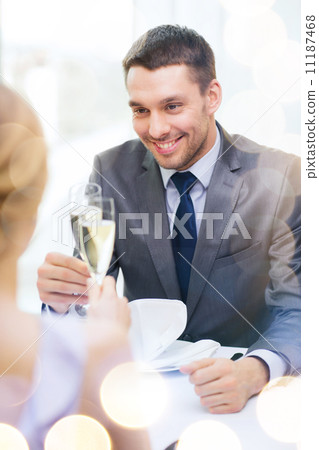 couple with glasses of champagne at restaurant couple with glasses of champagne at restaurant 11187468