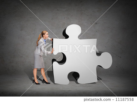 busy businesswoman pushing puzzle piece 11187558