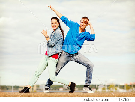 couple of teenagers dancing outside 11187653